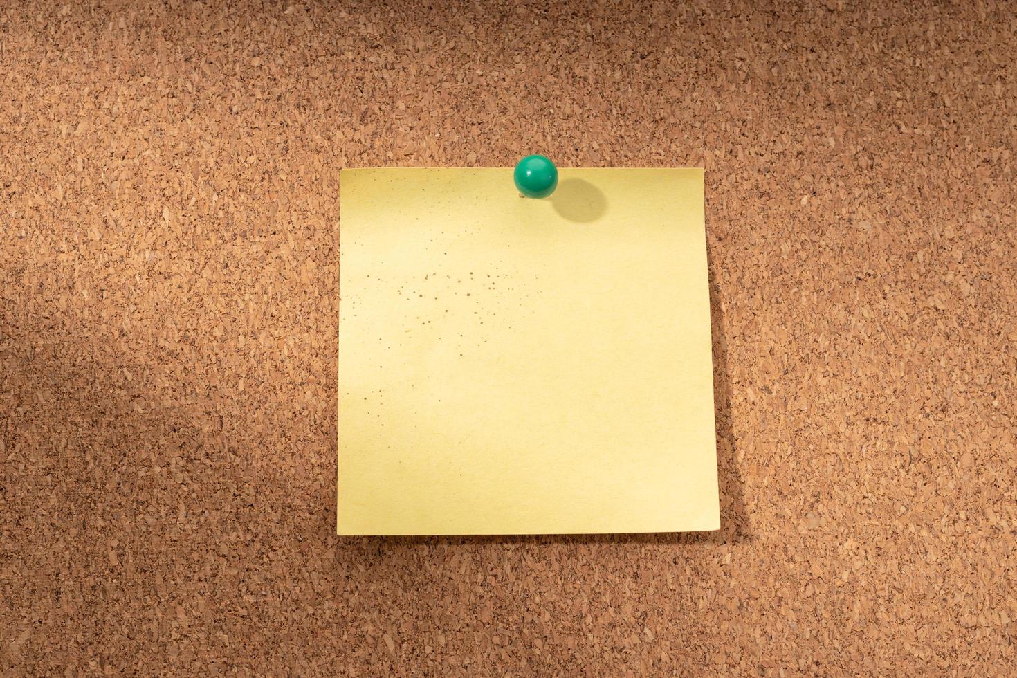 Cork board with blank yellow note for adding text photo
