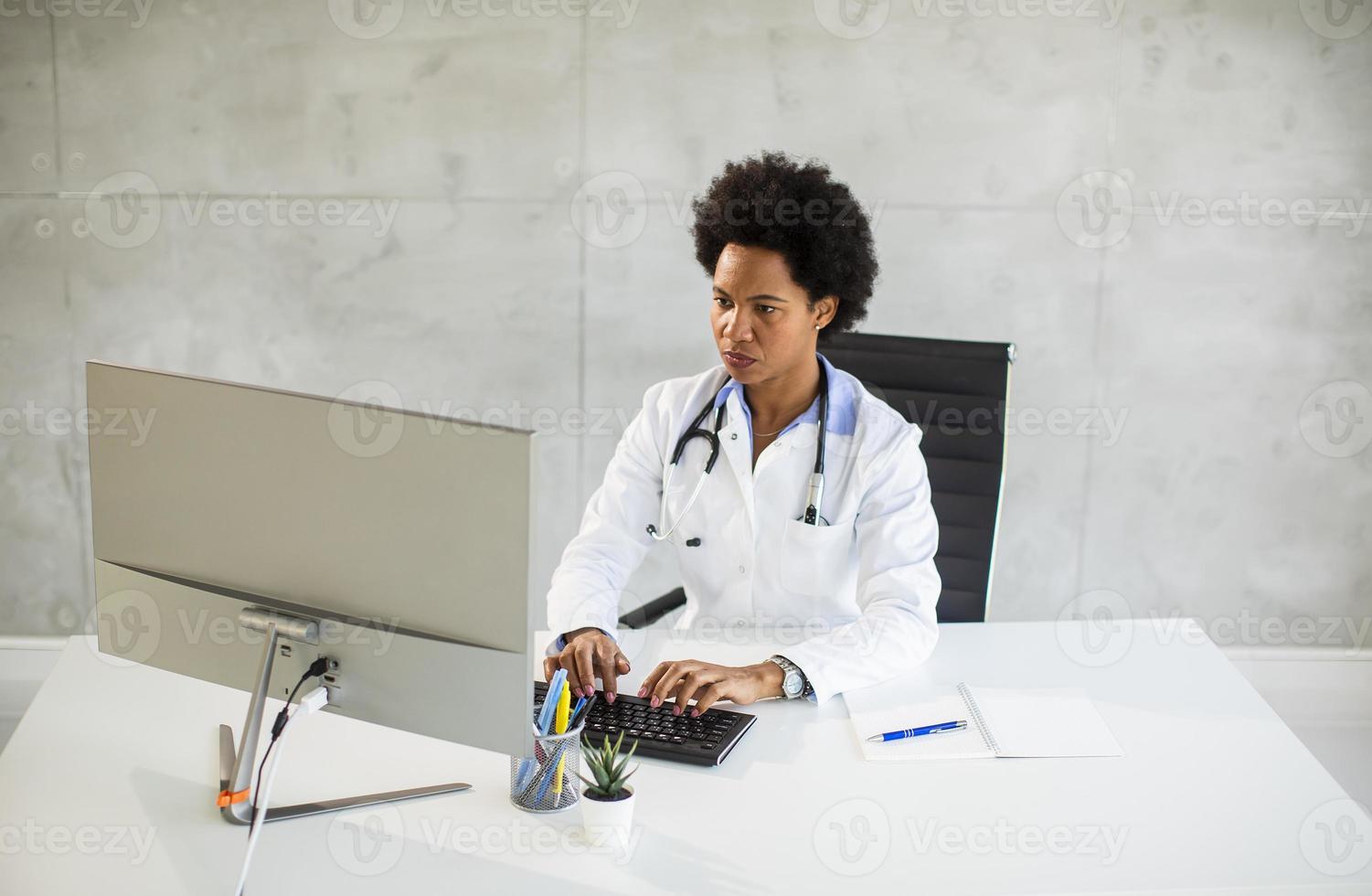 Doctor working in an office photo