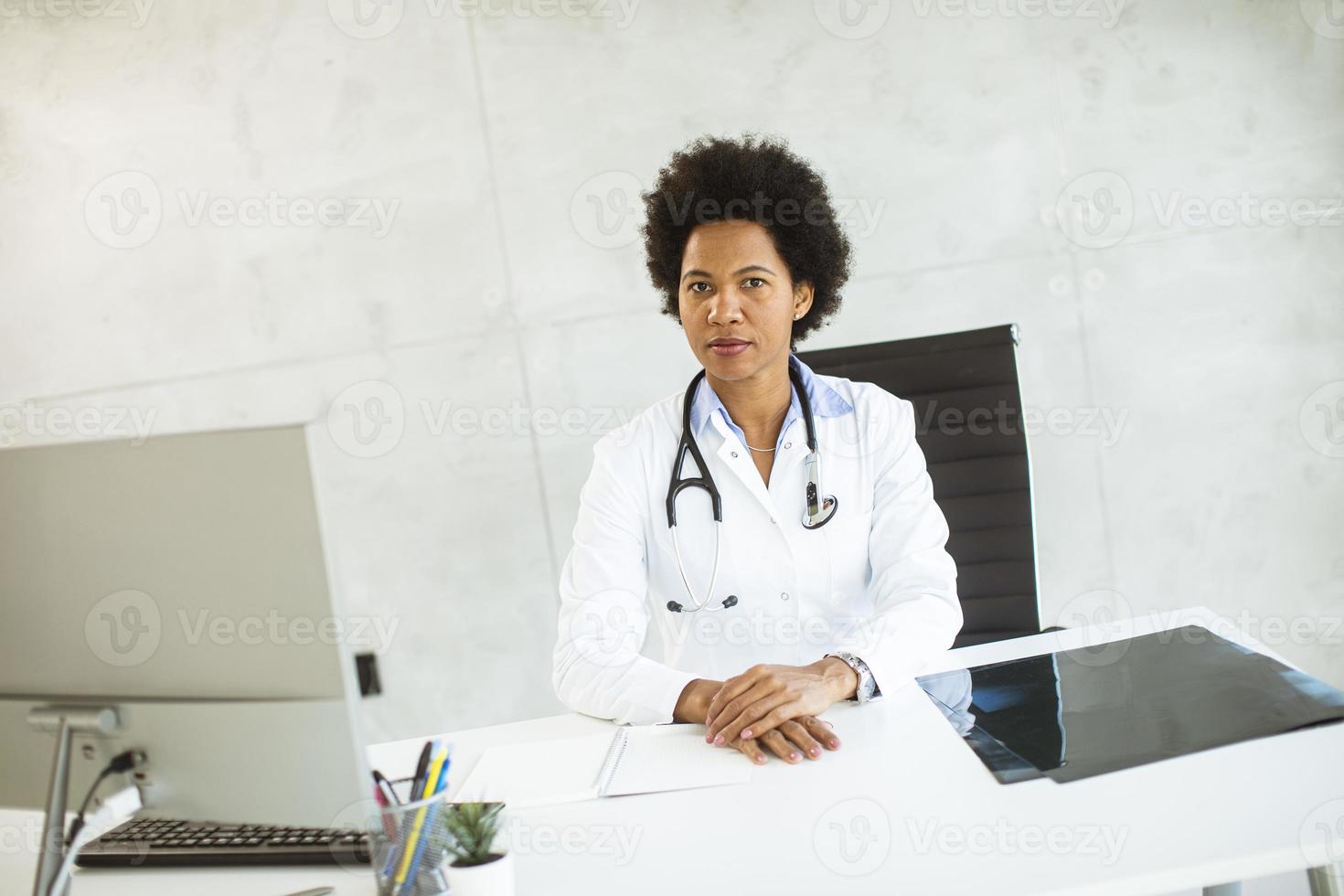 Doctor looking pensive behind a desk photo