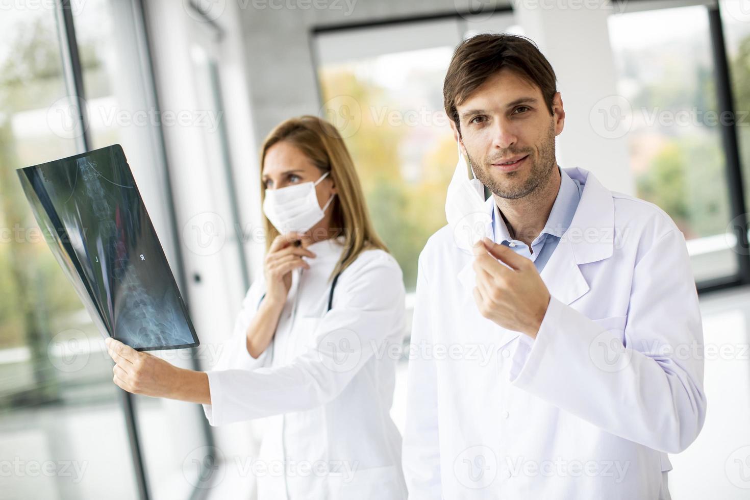 Doctor taking off his mask photo