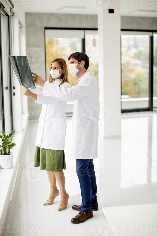 Vista vertical de médicos en máscaras con rayos x. foto