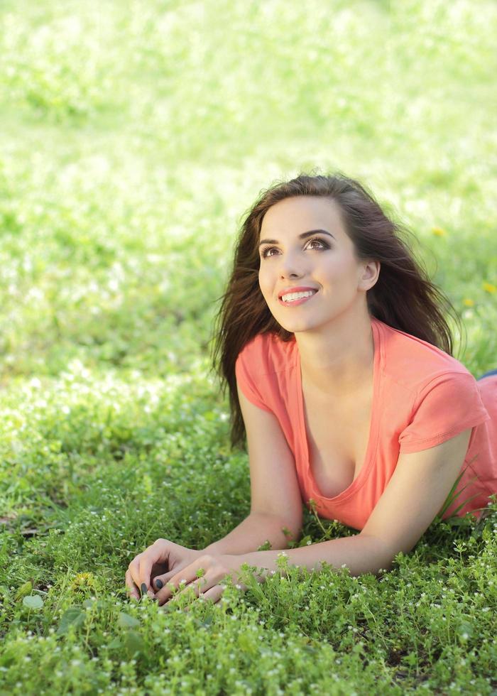 Woman lying in the grass and looking up photo