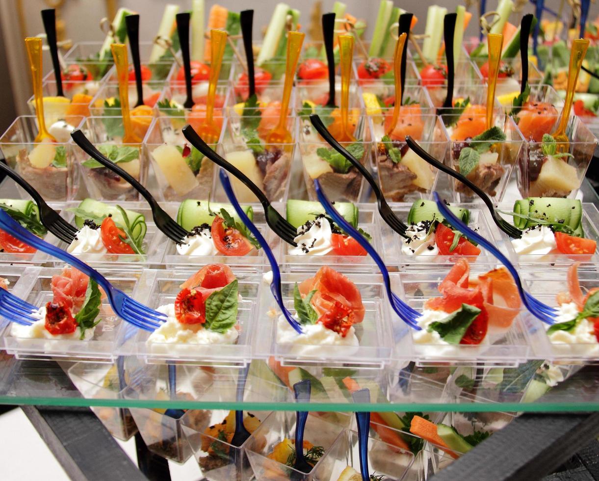 decorated catering banquet table with cheese tomato pate and cold snacks photo