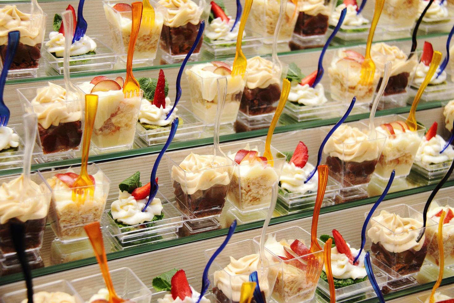 decorated catering banquet table with sweet cream and cold snacks photo