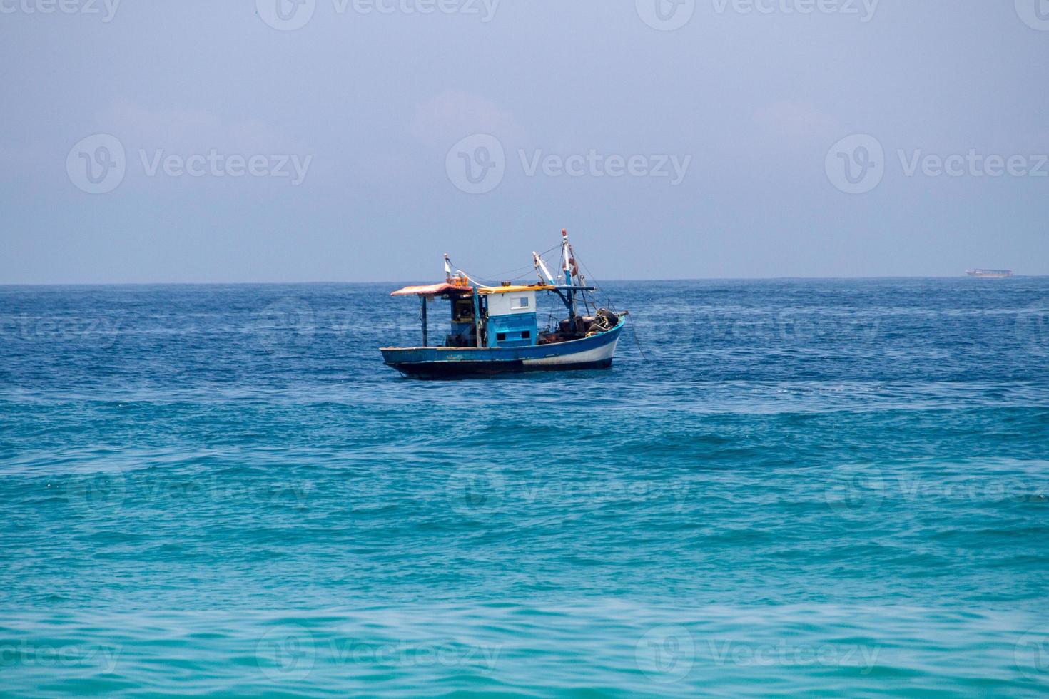 Fishing boat over the sea at Ipanema beach in Rio de Janeiro photo