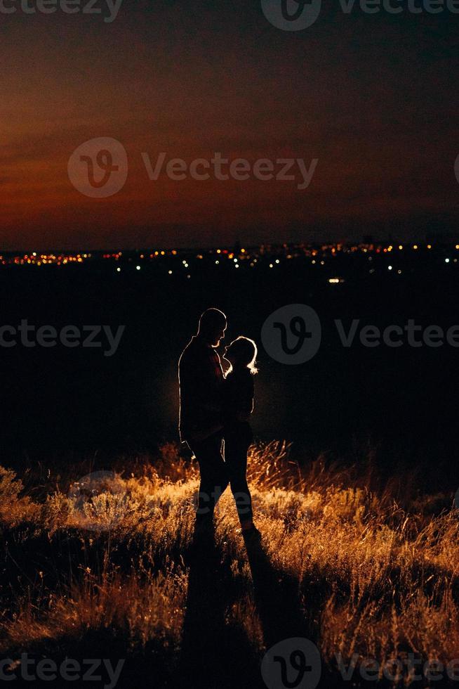 Young couple a guy and a girl in bright knitted hats stopped at a camping photo