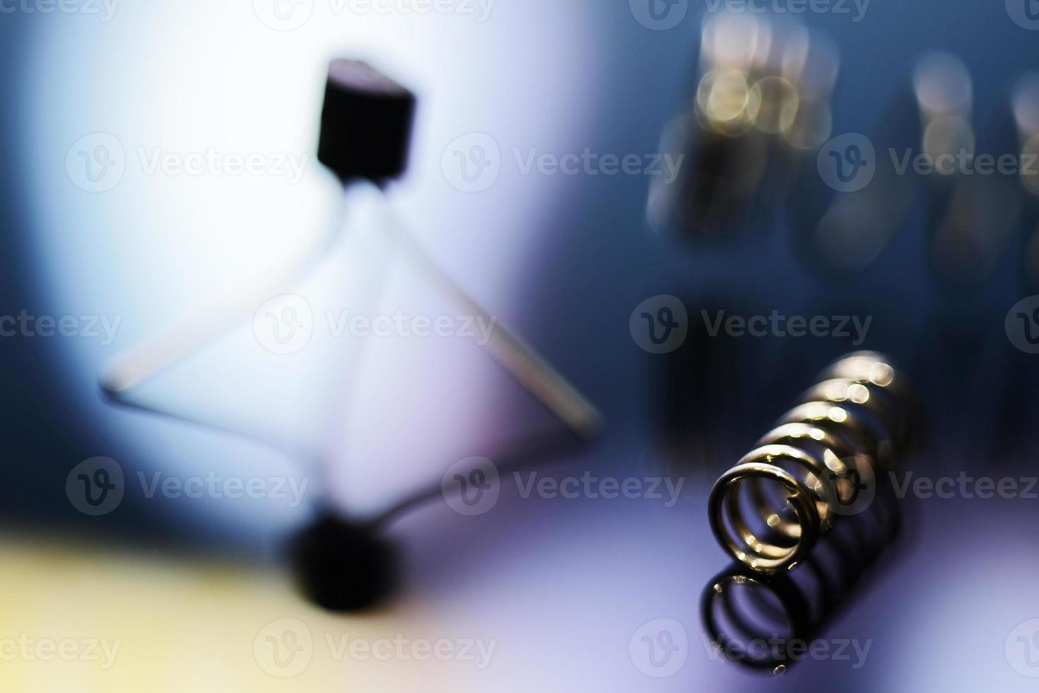 Macro image of a metal spring and electronic components in blur photo