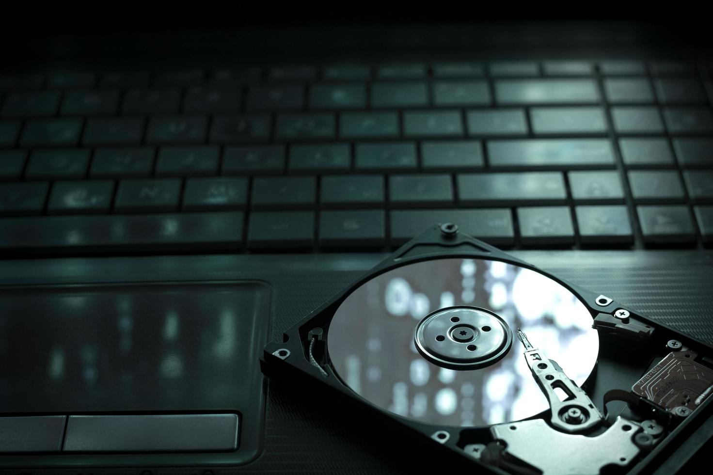 An open HDD on a laptop keyboard photo