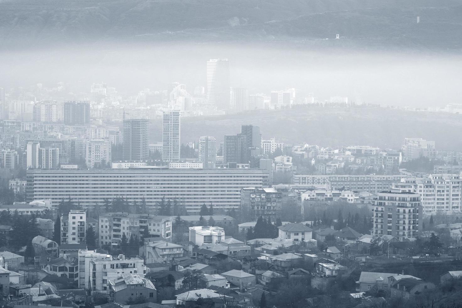 Heavily polluted city in blue monochrome photo