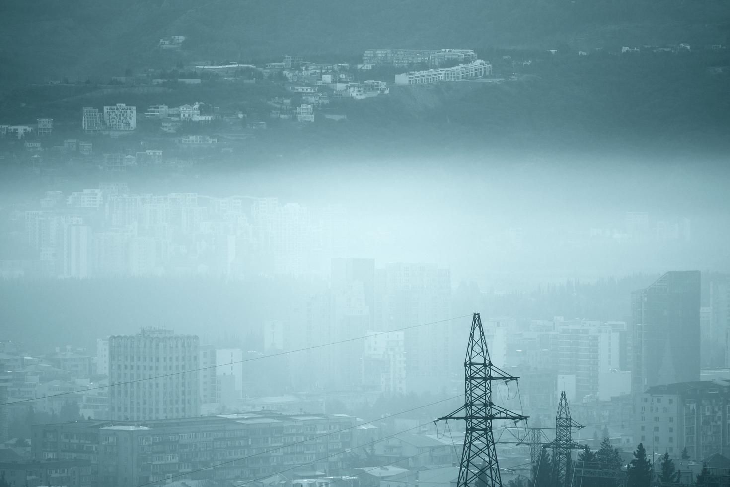 Heavily polluted city in blue monochrome photo