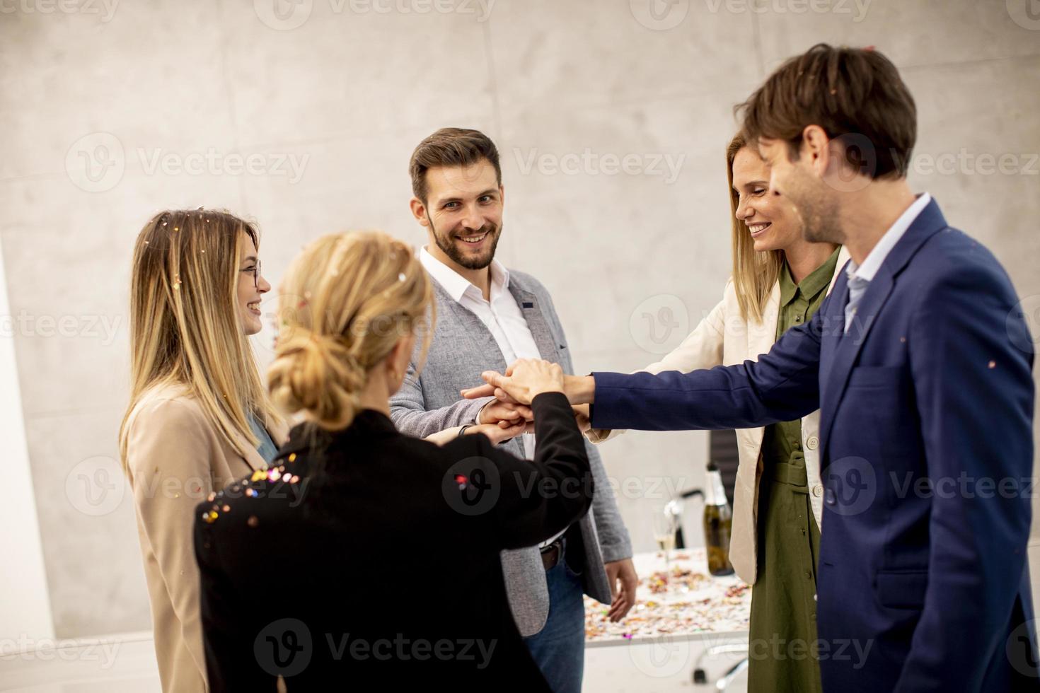 Professionals joining hands together as a team photo