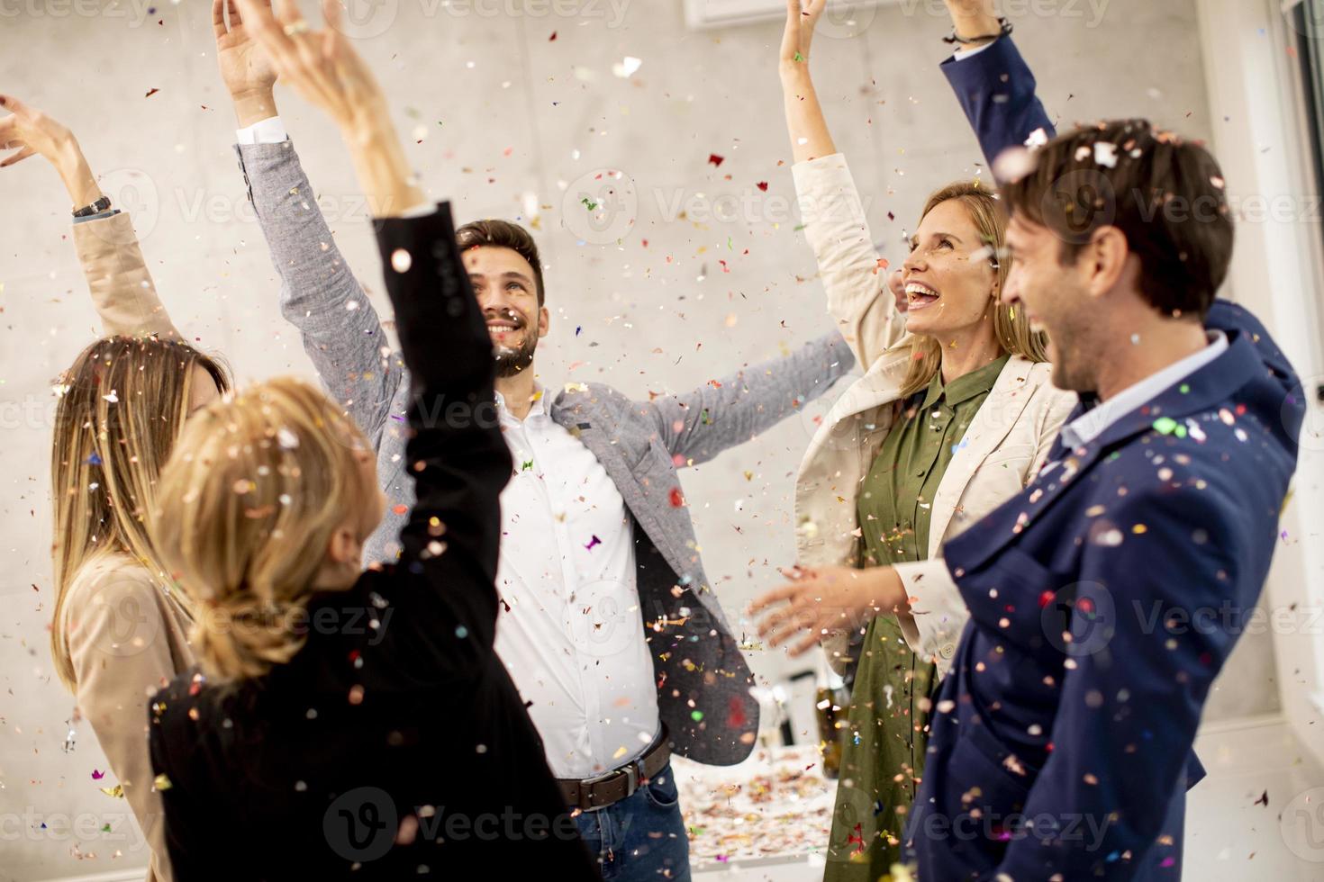 Business professionals celebrating with confetti photo