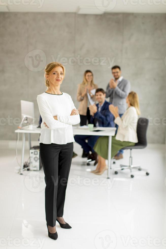 Woman standing in front of team photo