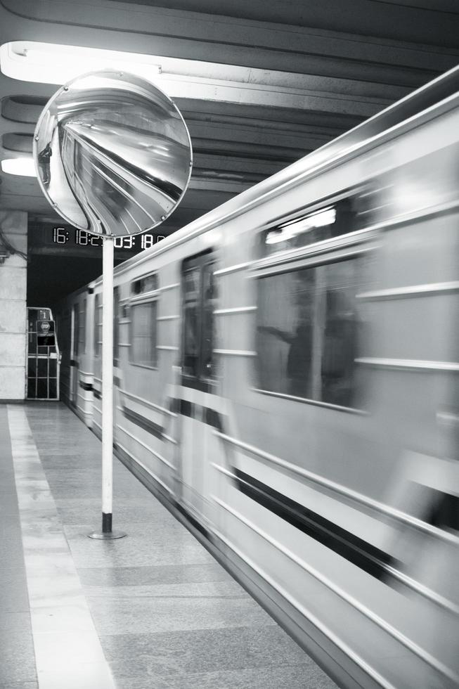 A moving train reflected in a round mirror photo