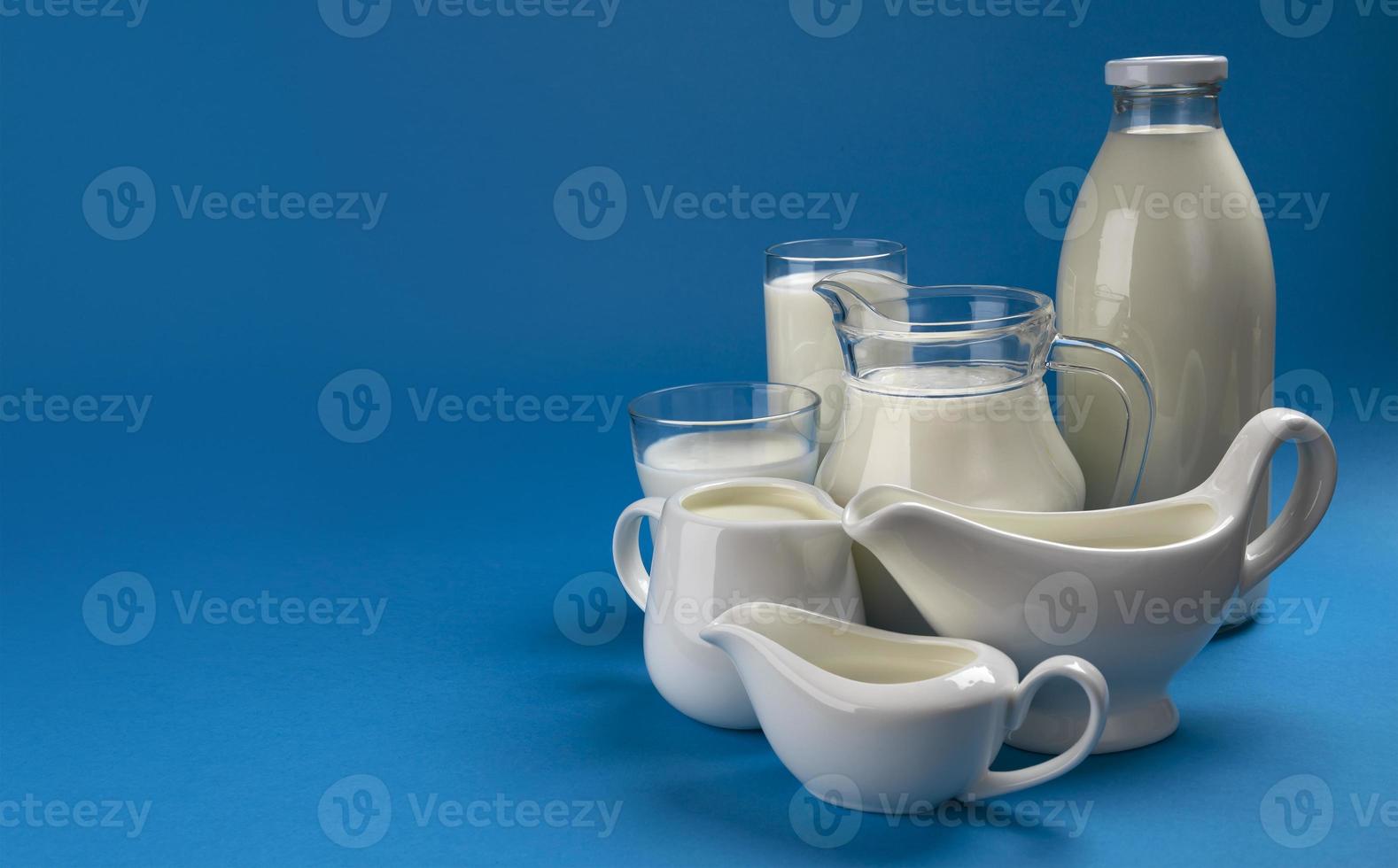 Collection of dairy products on blue wooden background photo
