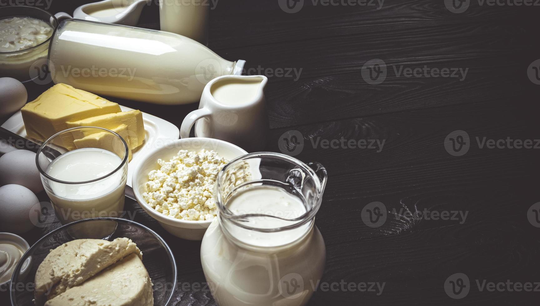 Dairy products on black wooden background top view photo