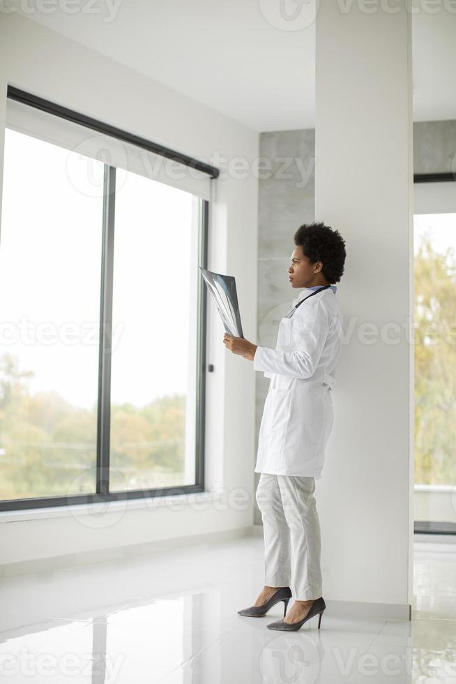 Doctor in a modern office looking at an x-ray photo