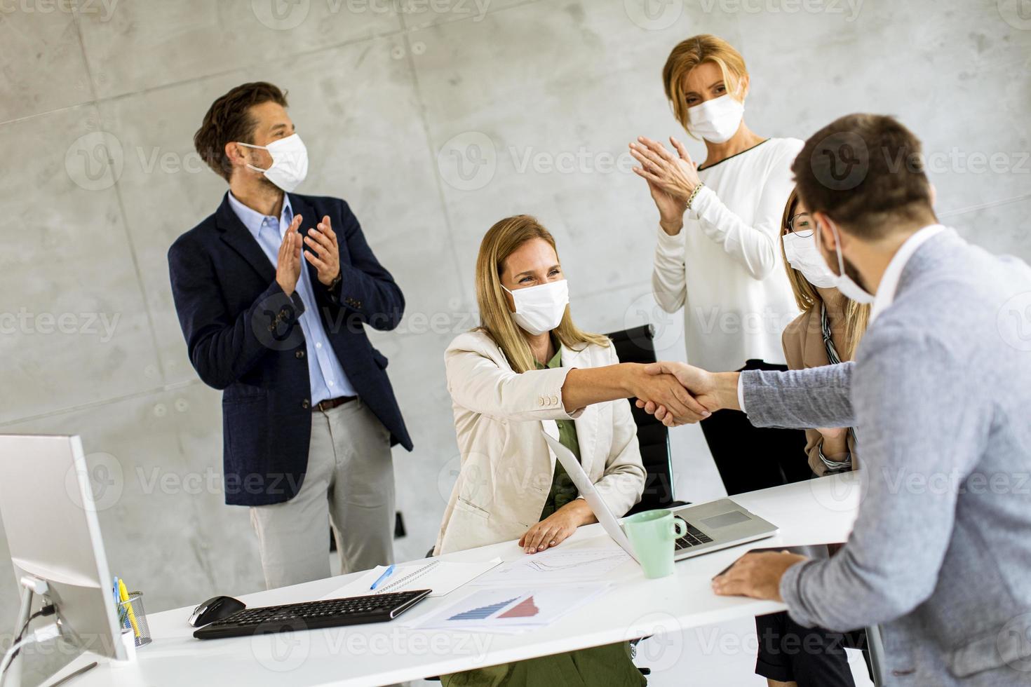 Business agreement with masks on photo