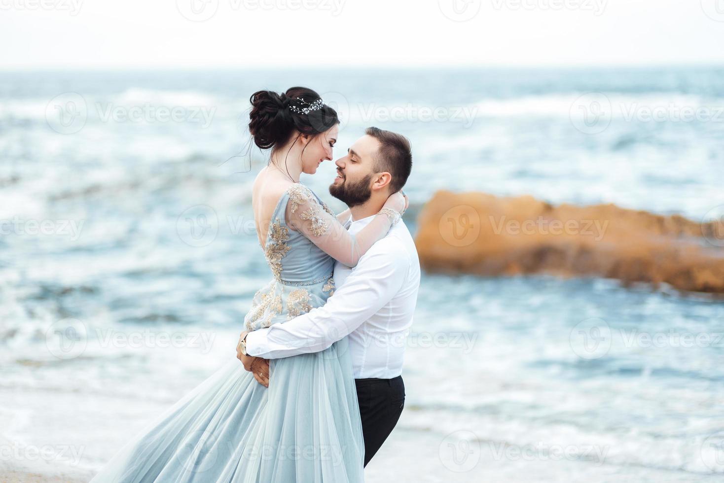 Same couple with a bride in a blue dress walk photo