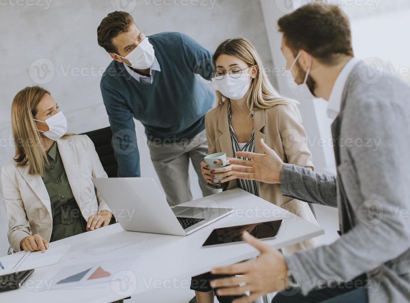 Professionals in discussion with masks on photo