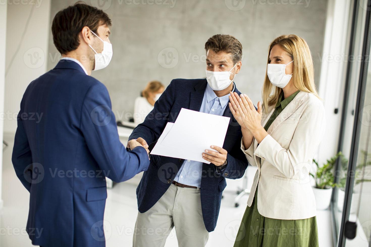 Three masked professionals meeting photo