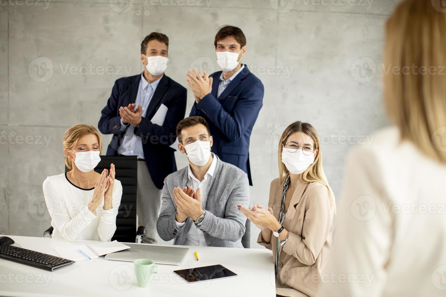Close-up of speaker talking to masked team photo