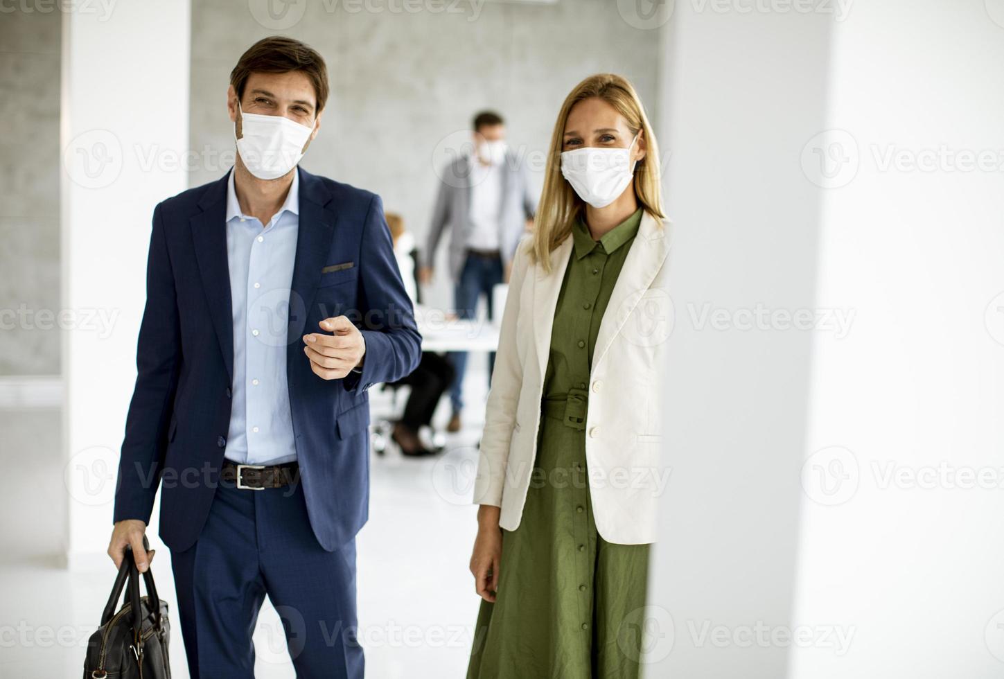 Two masked business professionals with copy space photo