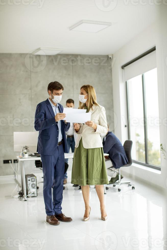 Vertical view of masked professionals photo