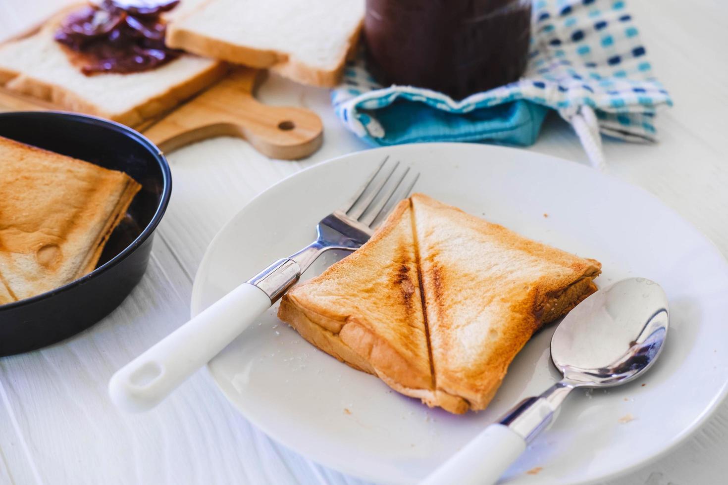 Roasted toast bread popping up of a stainless steel toaster in a home kitchen. photo