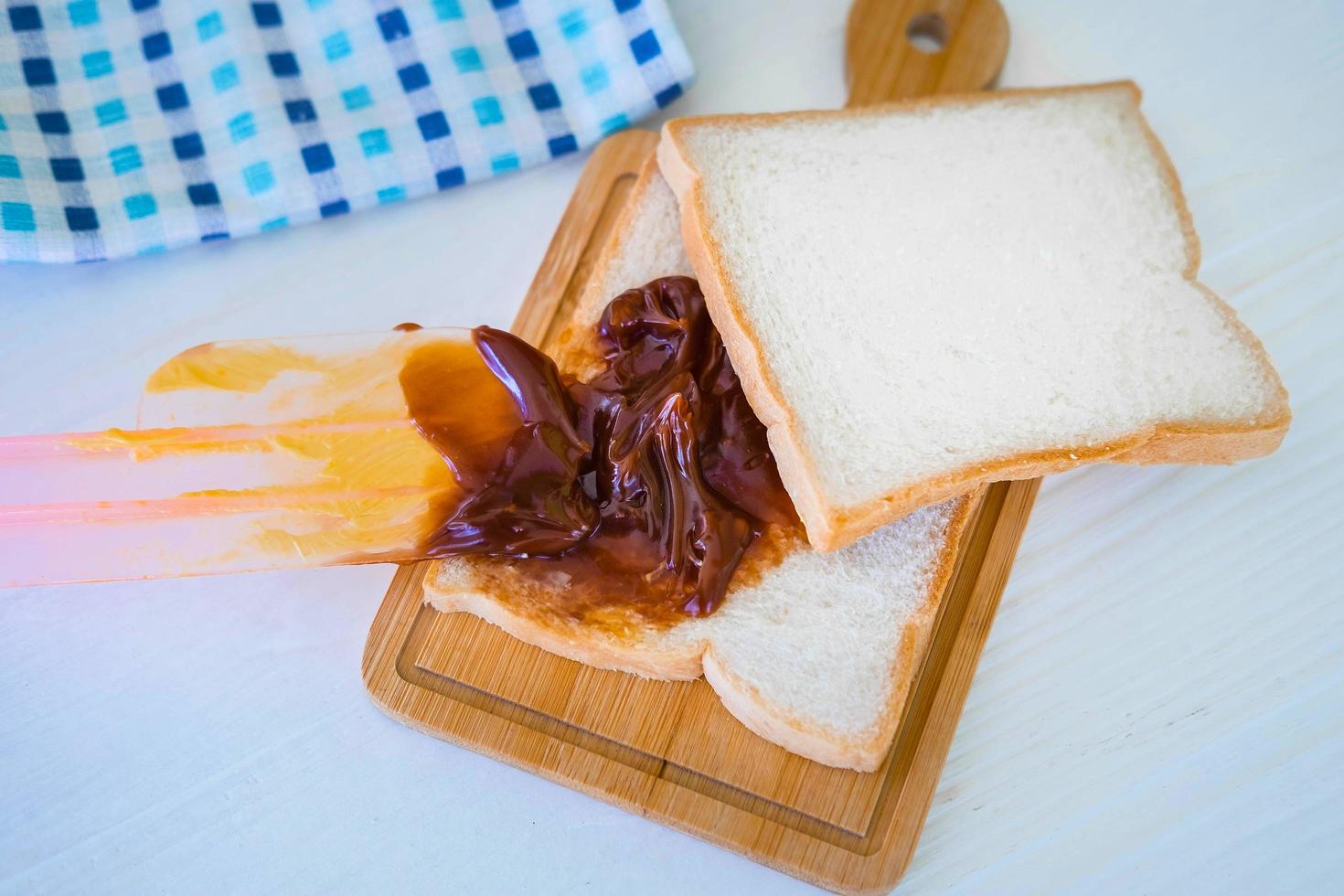 Roasted toast bread popping up of a stainless steel toaster in a home kitchen. photo