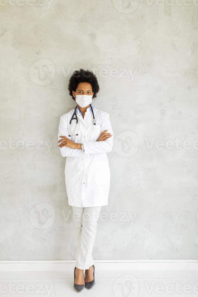 Vertical view of a doctor leaning against wall photo