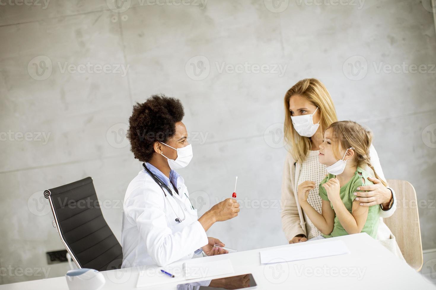 Doctor giving child a checkup photo