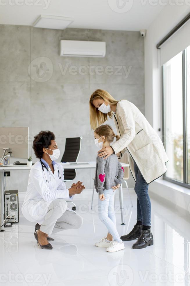 Pediatrician giving child a checkup photo