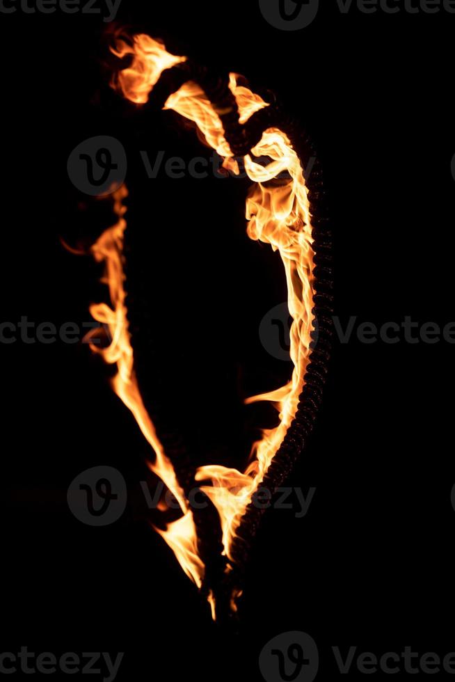 Burning heart with flames Isolated on dark background photo