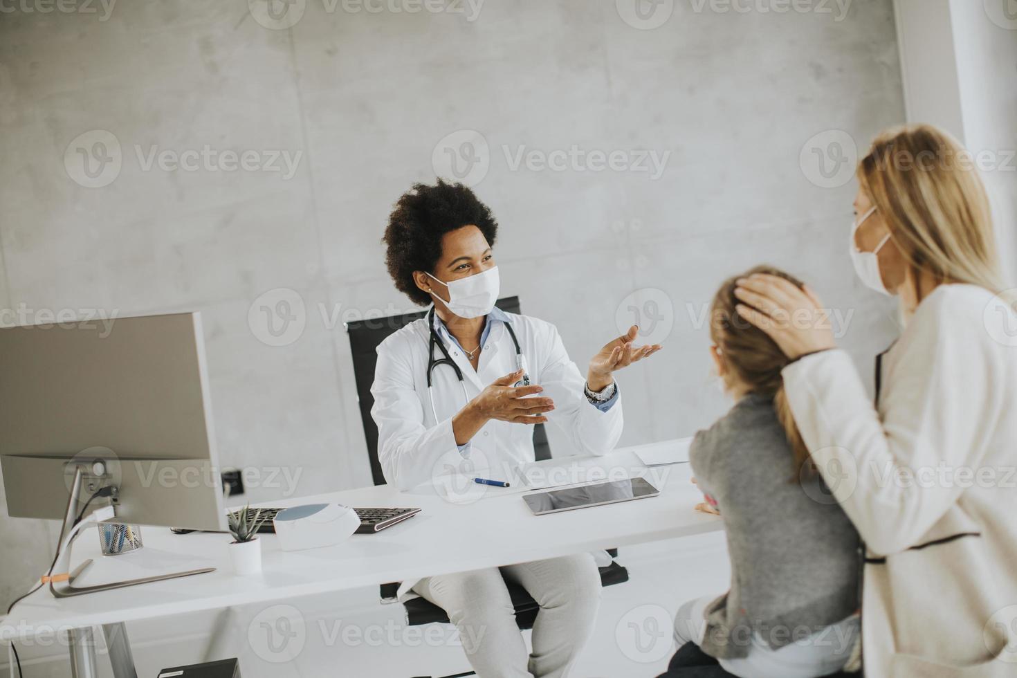 Doctor talking to mother and patient photo