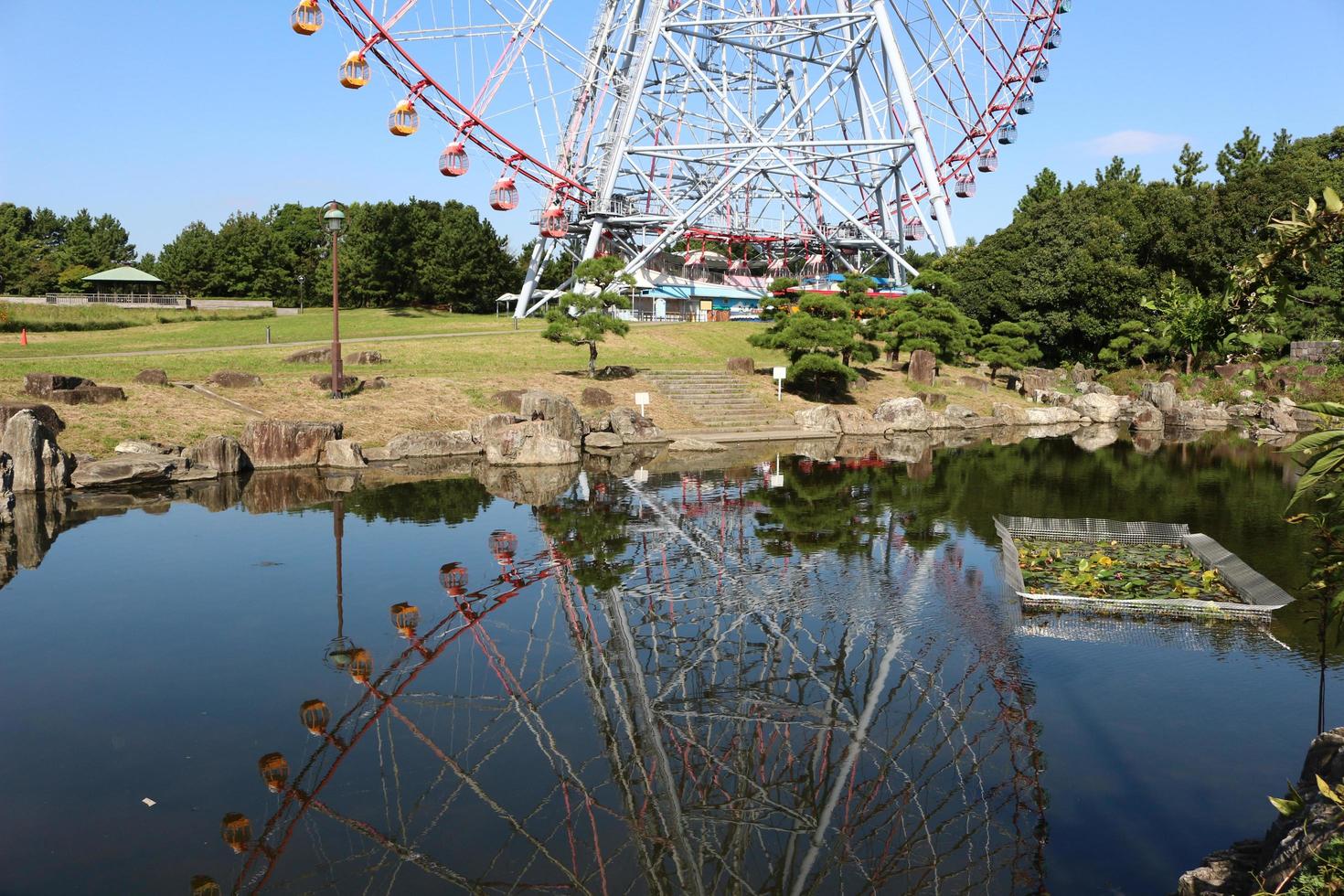 Ferris wheel at the amusement park with blue sky photo