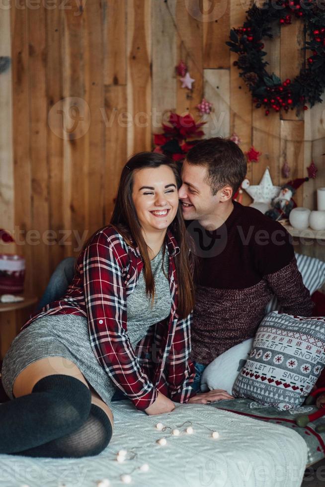 Guy and a girl celebrate the new year together and give each other gifts photo
