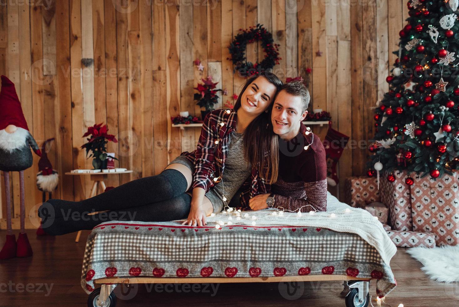 Guy and a girl celebrate the new year together and give each other gifts photo