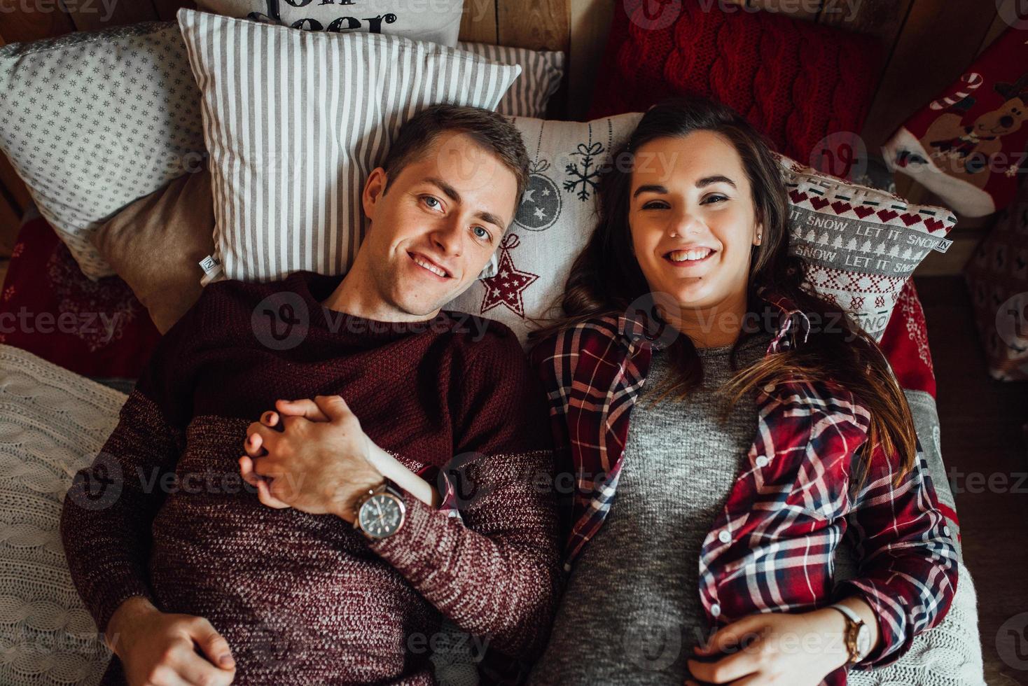 Guy and a girl celebrate the new year together and give each other gifts photo