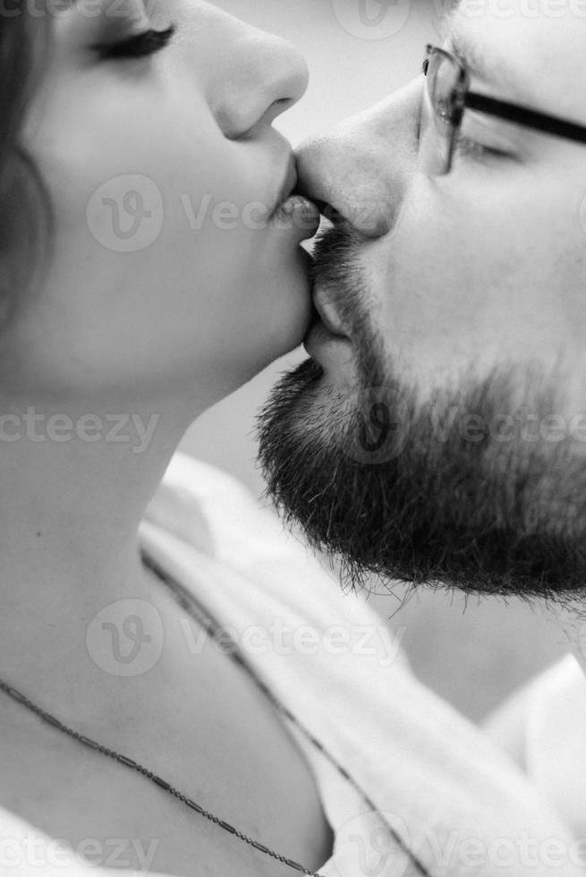 Young couple in love a guy with a beard and a girl with dark hair in light clothes photo