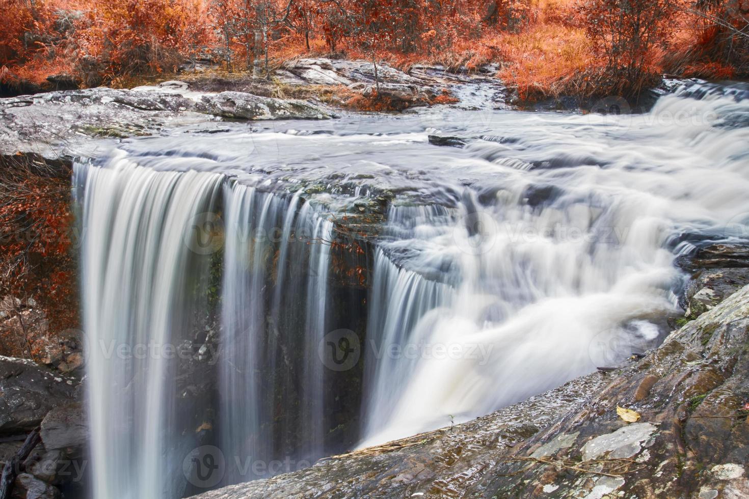 Autumn waterfall in deep forest photo