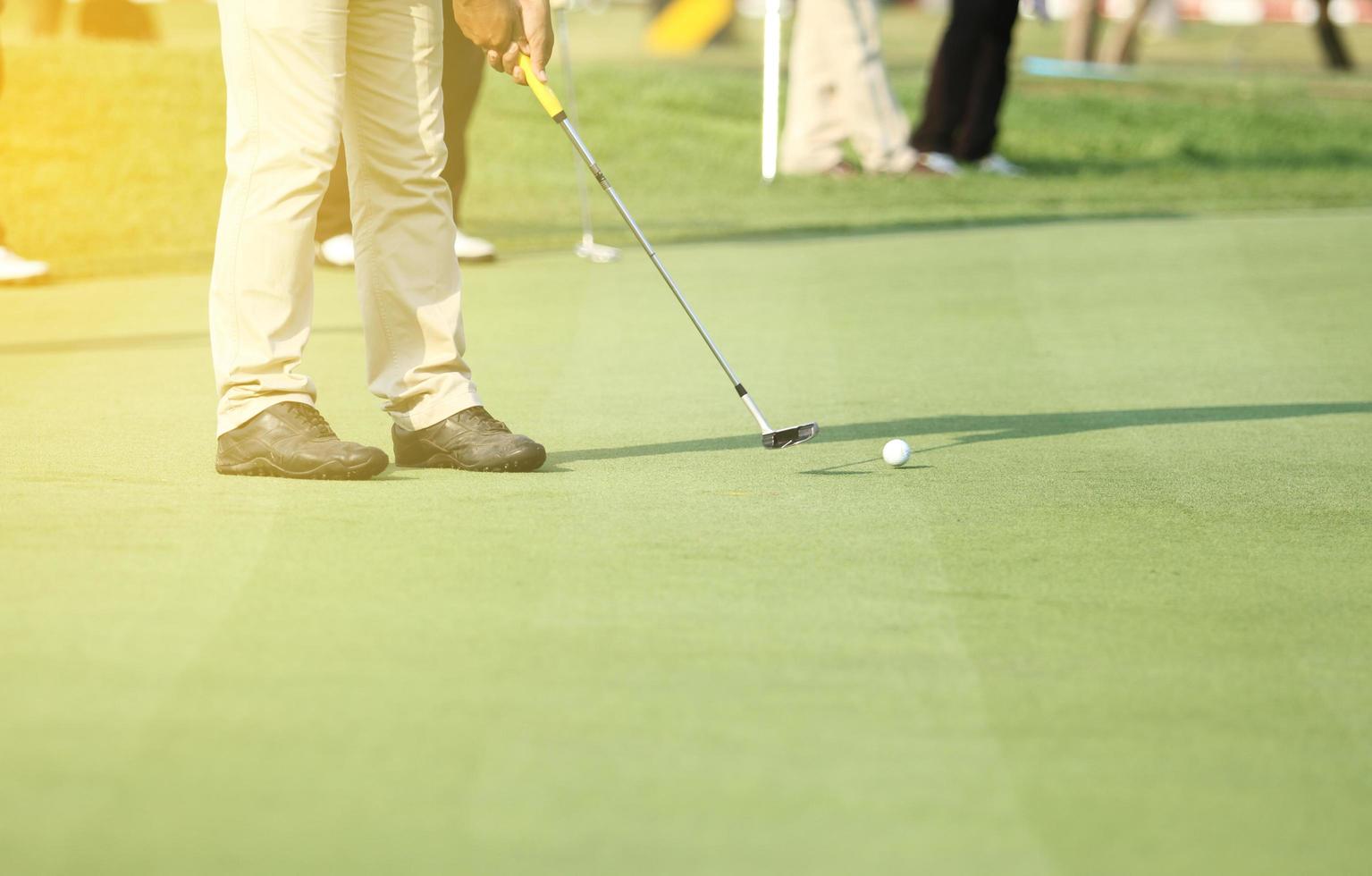 Golfer putting on the green photo