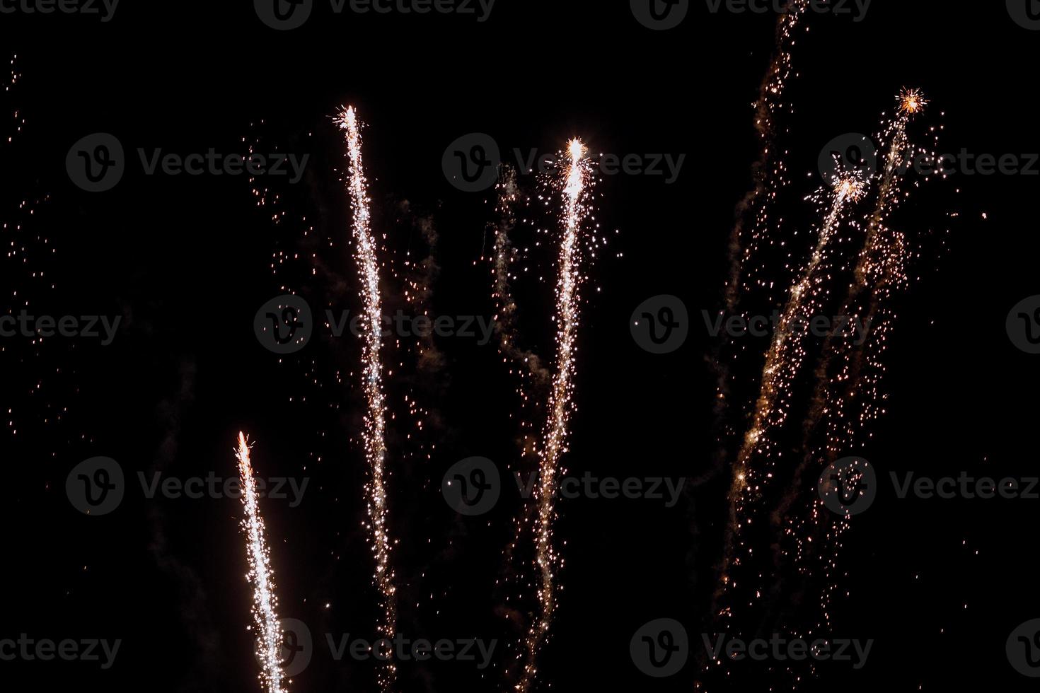 Real fireworks on deep black background sky photo