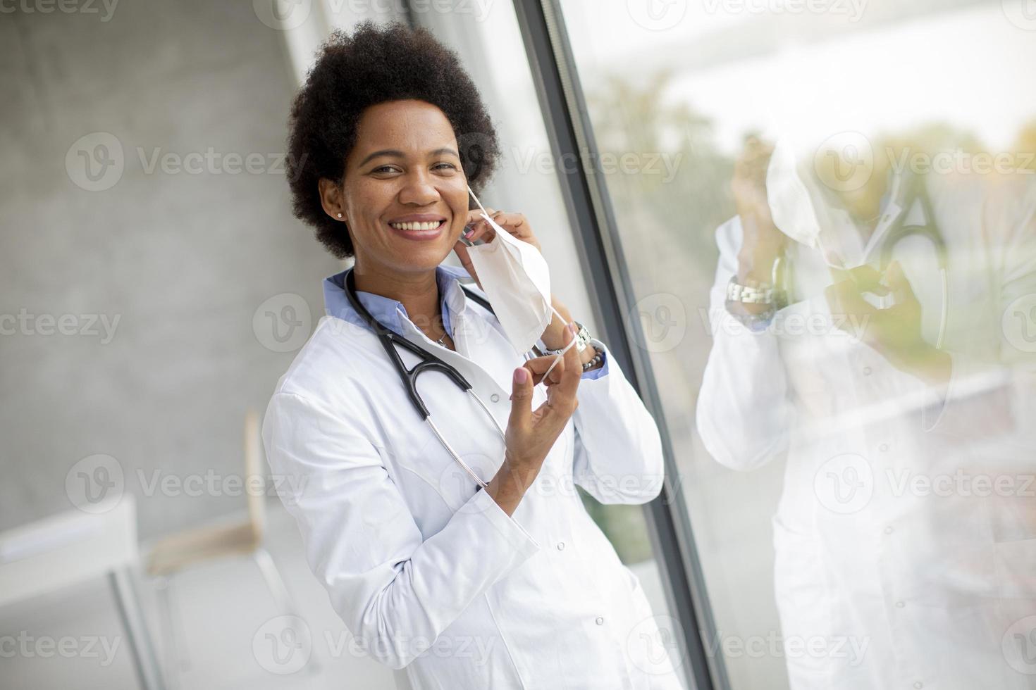 Doctor putting on her mask photo