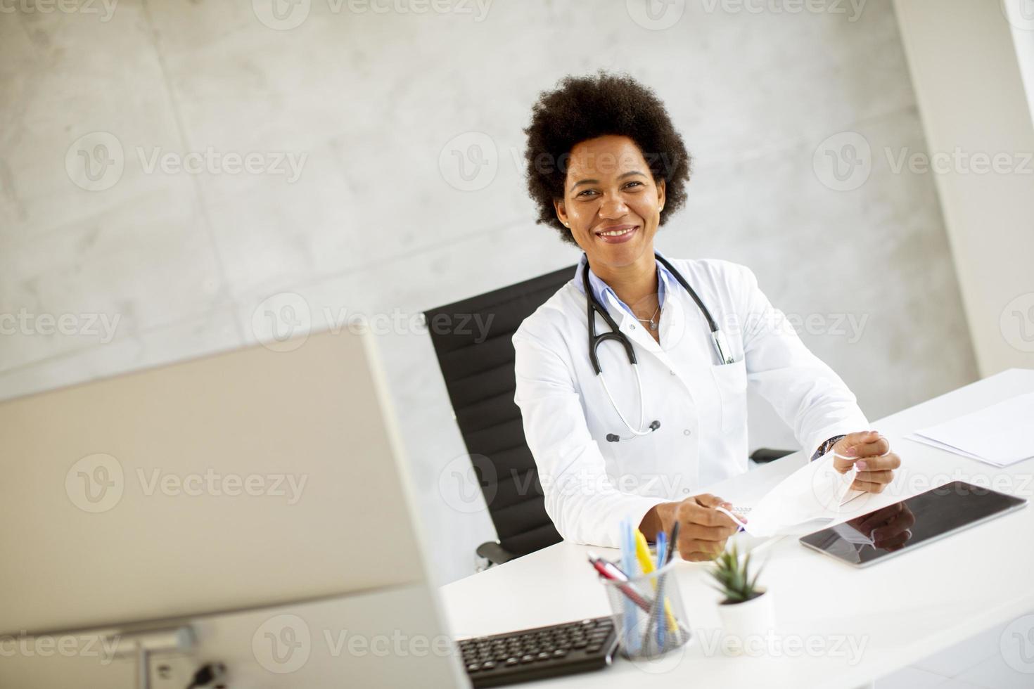 Doctor posed at desk photo