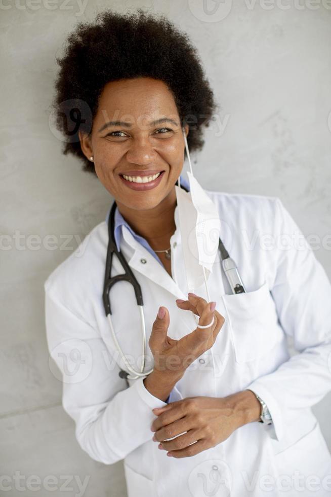 Close-up of a doctor taking off her mask photo