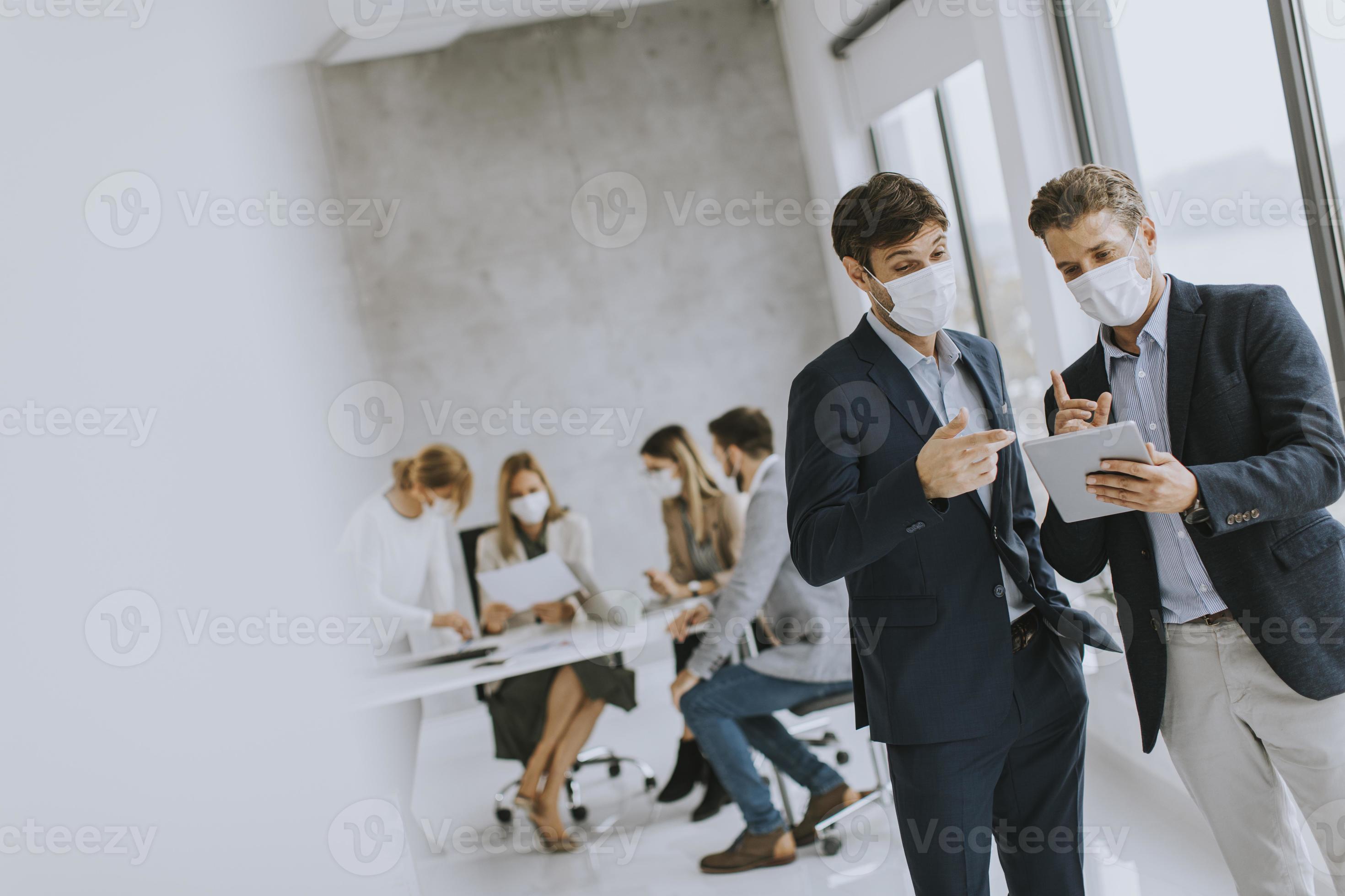 Two young business men with wearing masks photo