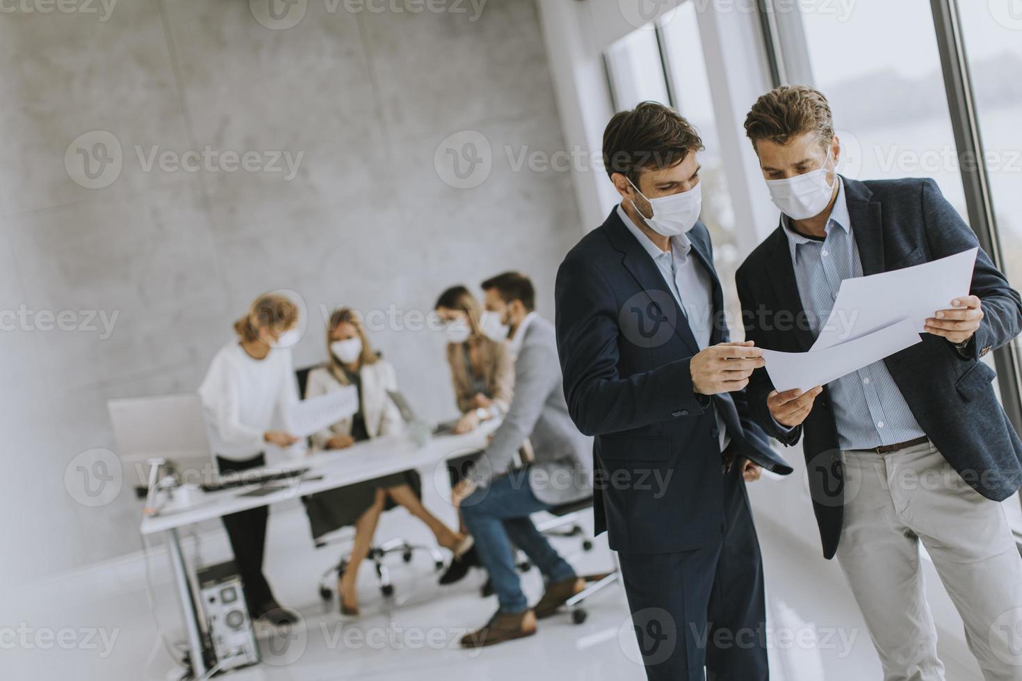 Two men meeting in masks photo