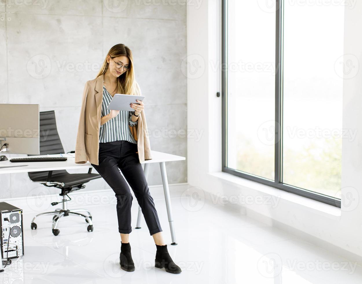 Businesswoman using a tablet with copy space photo