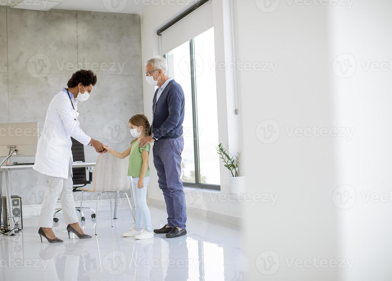 Grandchild and grandparent in doctor's office with copy space photo